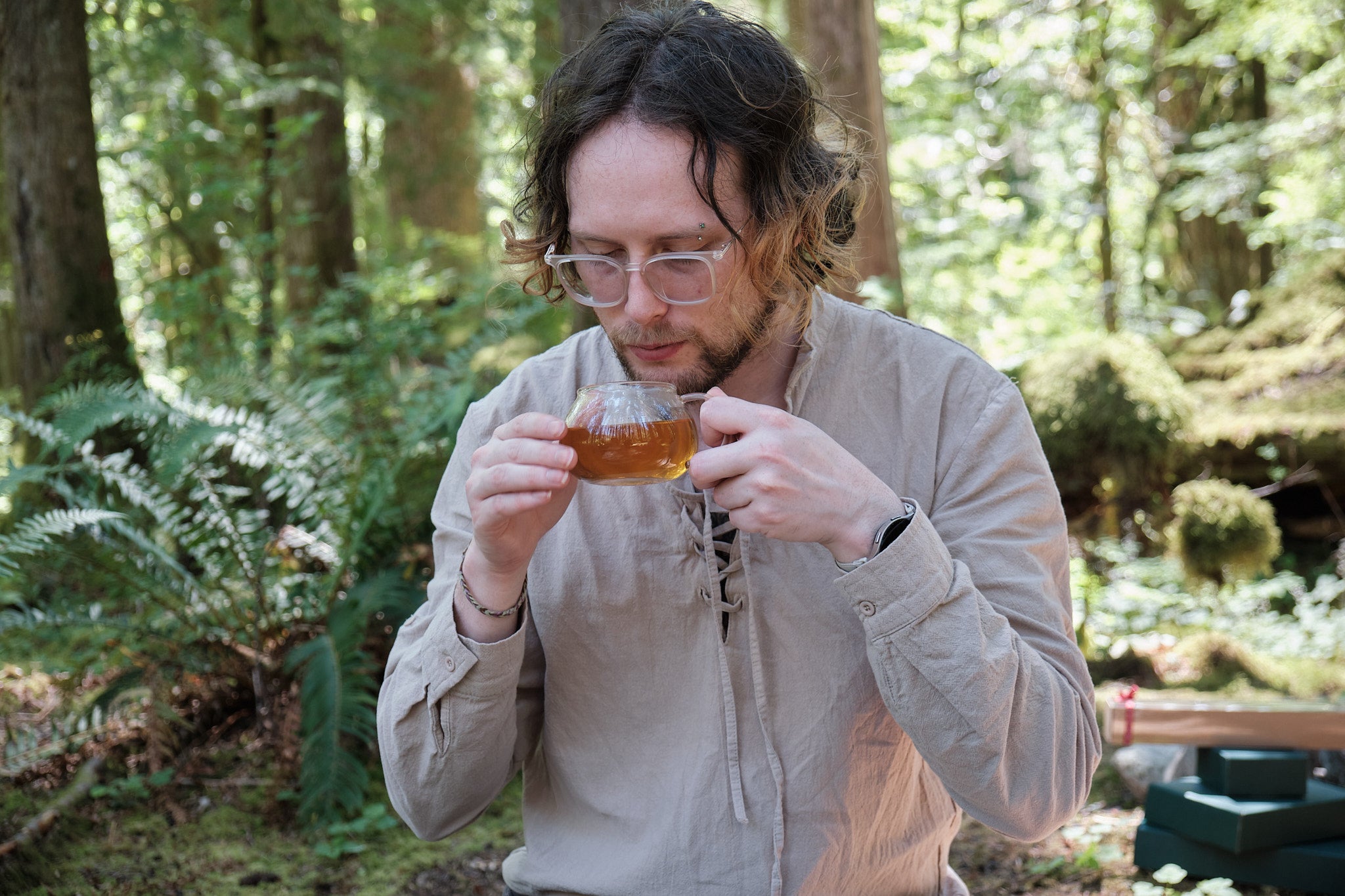 Jordan sipping a cup of tea in the woods