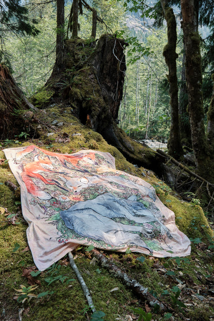 Fuzzy blanket featuring 5 sleeping foxes laid on a bed of moss