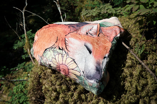 Folded up fuzzy blanket featuring a sleeping fox