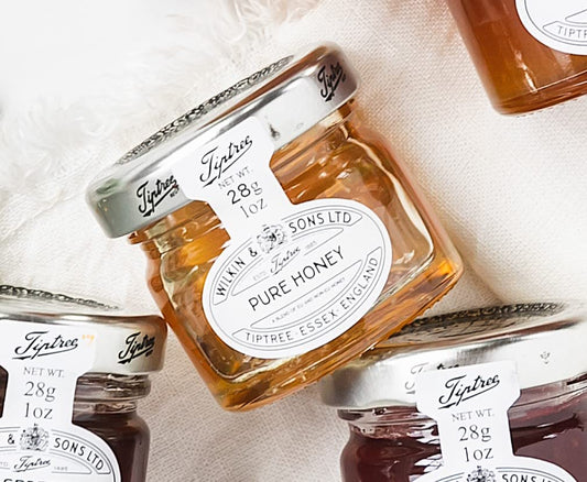 Jar of honey with tiptree branding.