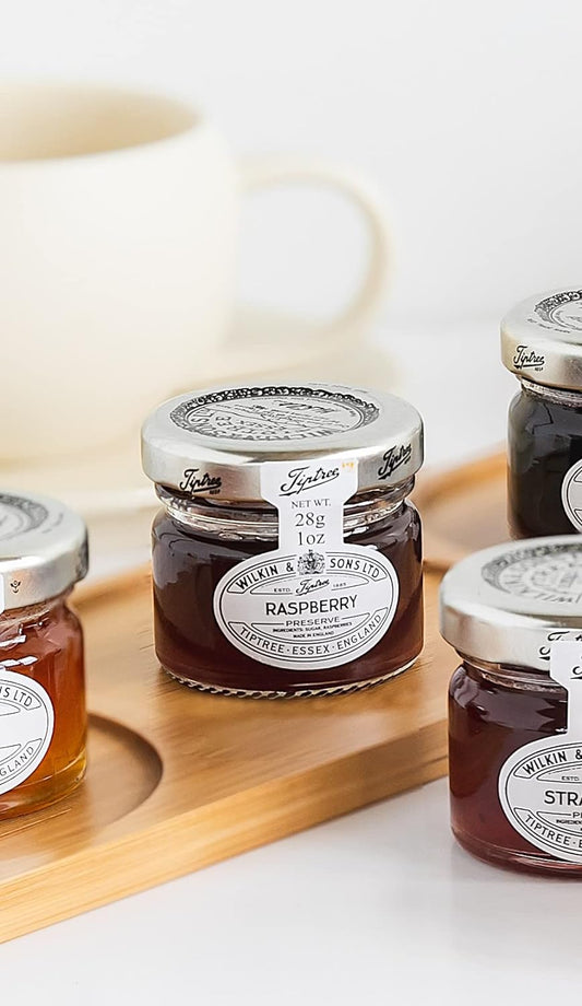 Jar of raspberry preserves with tiptree branding.